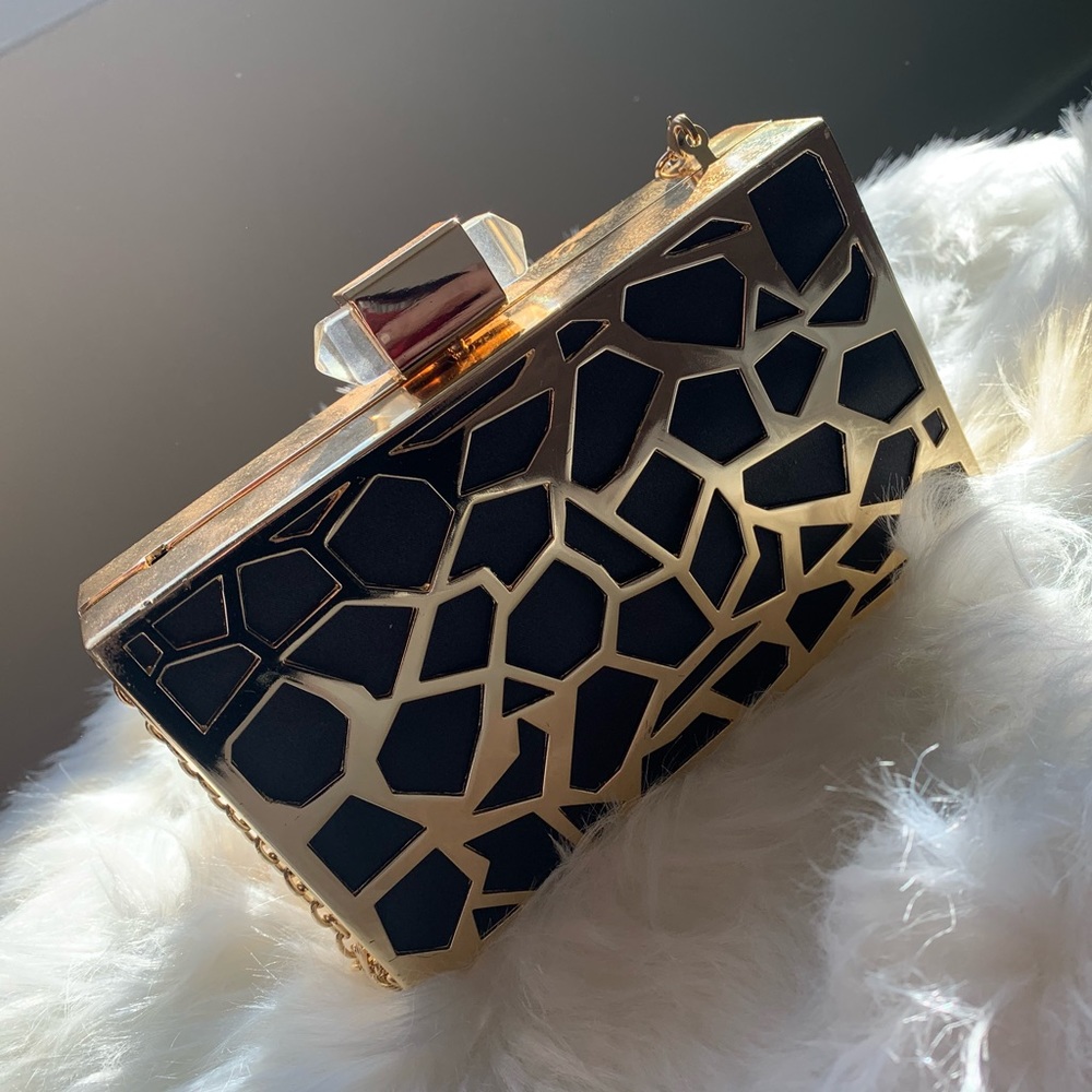 Gold shell clutch w/ black polyester giraffe like pattern. Comes w/ gold chain.